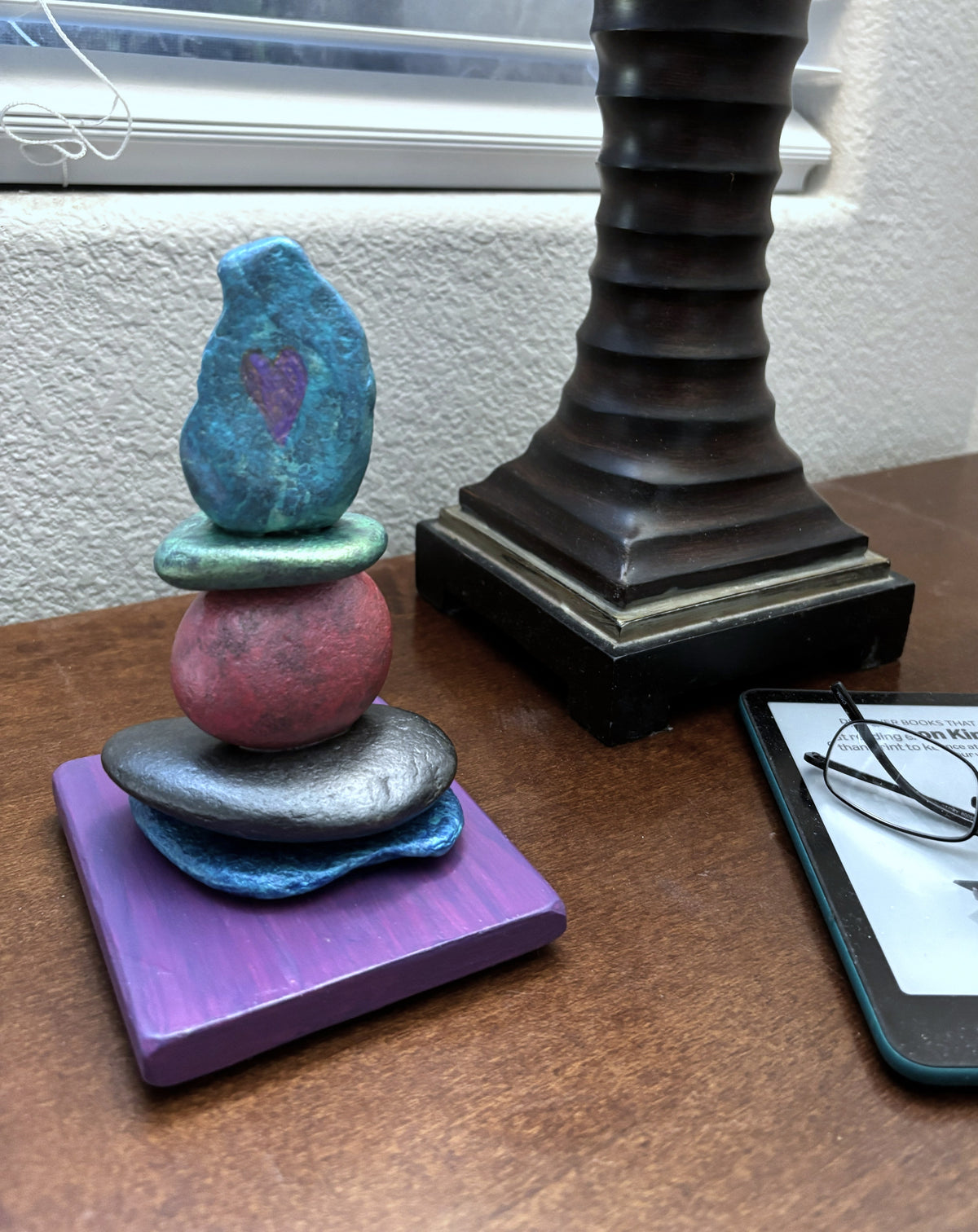 Vibrant jewel toned stacked river rock sculpture by Robert Schott