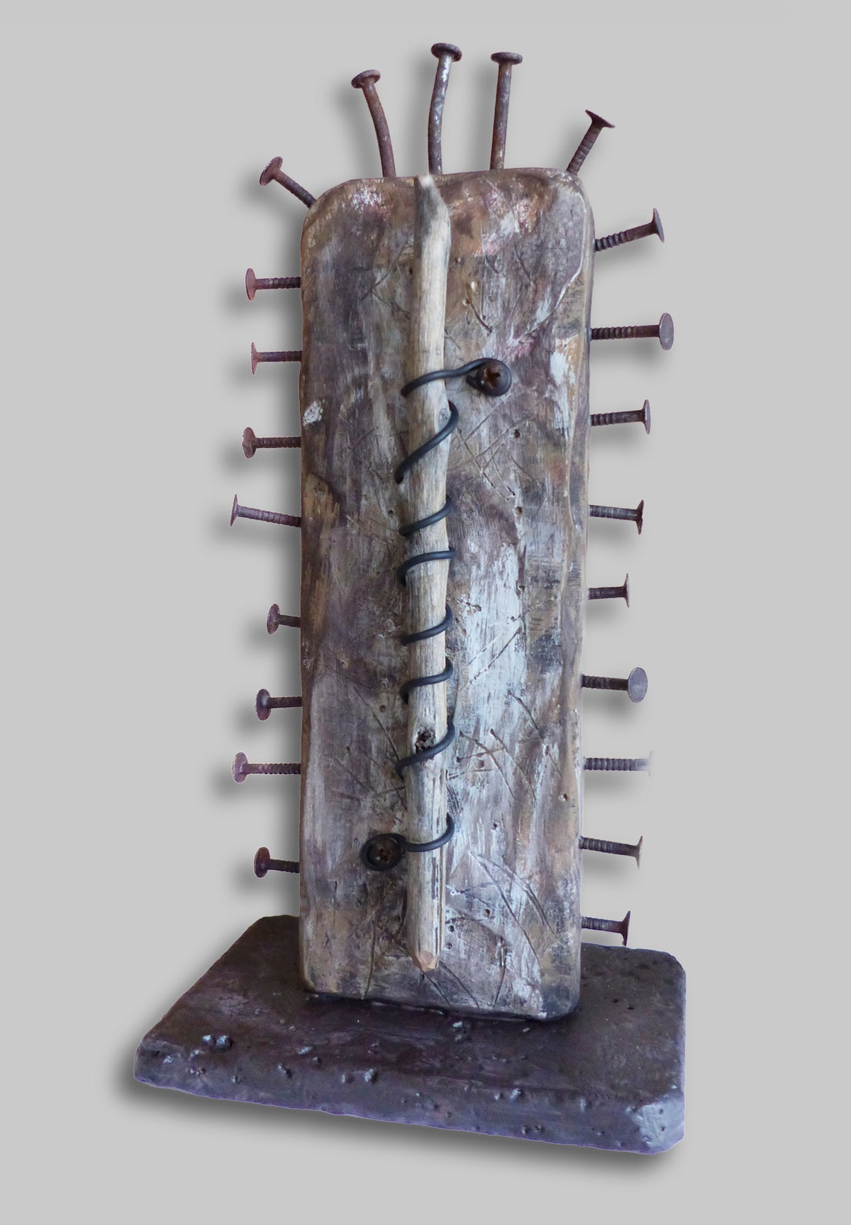  rustic sculpture featuring a weathered rectangular panel with embedded nails and a black steel cord 
