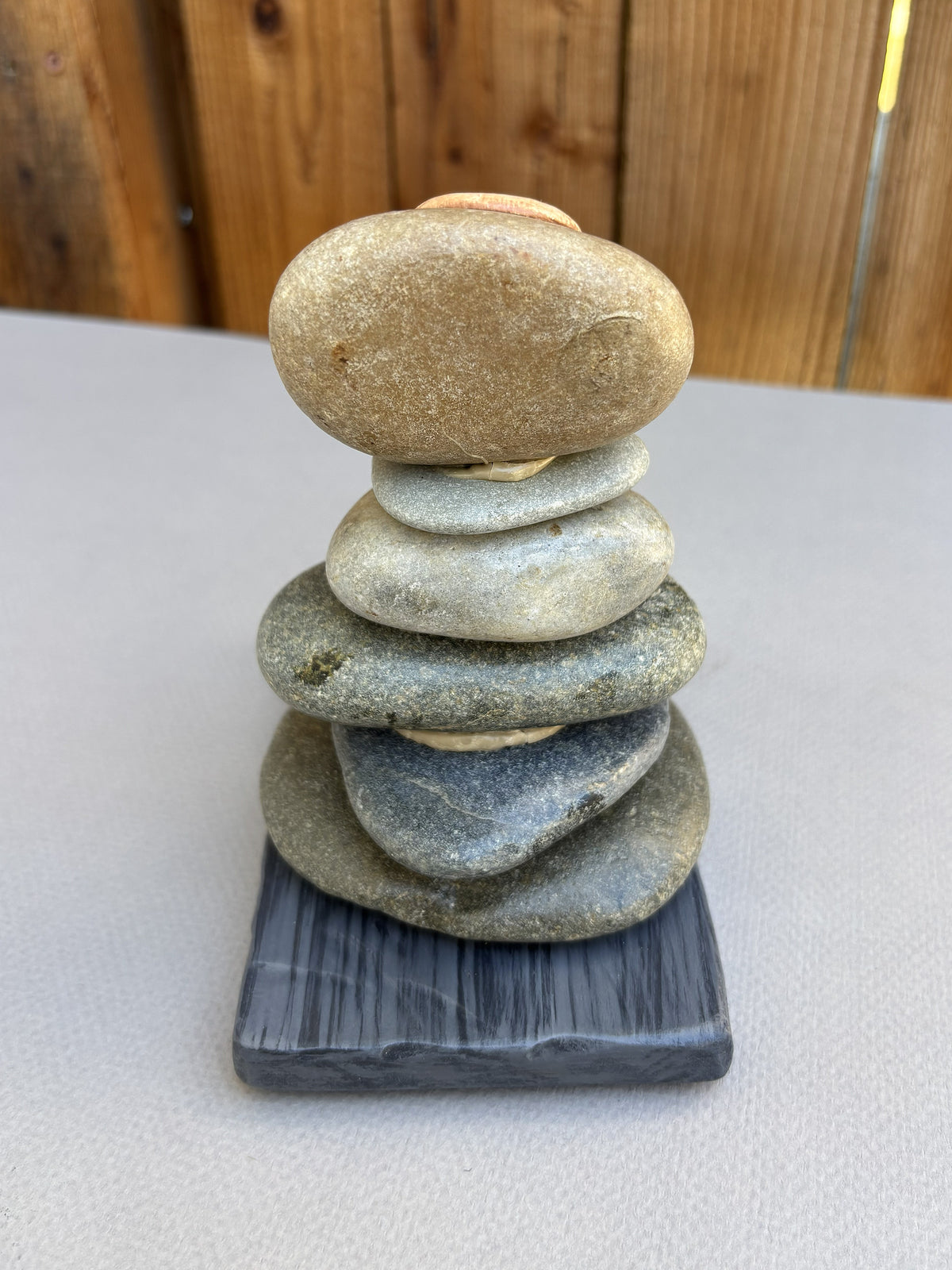 Back view of six stone cairn sculpture.