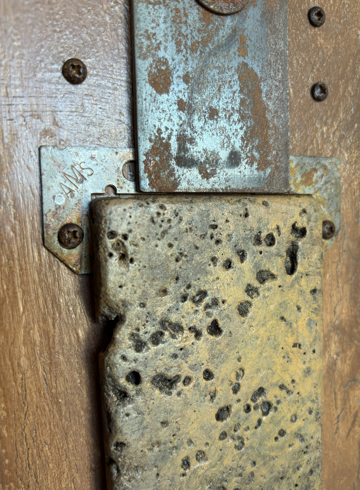 detail from the sculpture Great Empires by Robert Schott, it shows aged steel and marble with aged hardware and reclaimed wood.