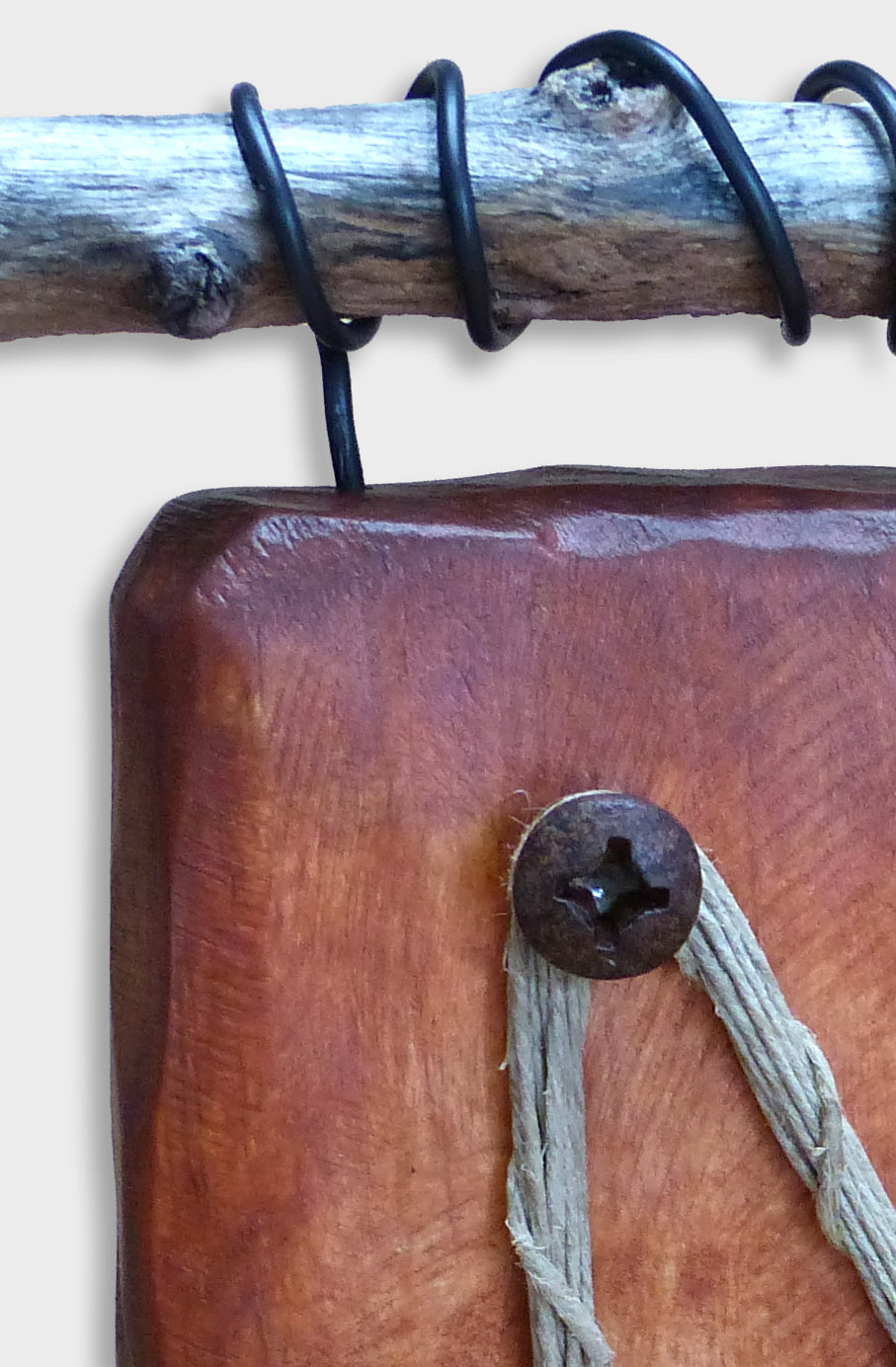 Detail showing a found wood piece with coiled steel from a small rustic sculpture by Robert Schott