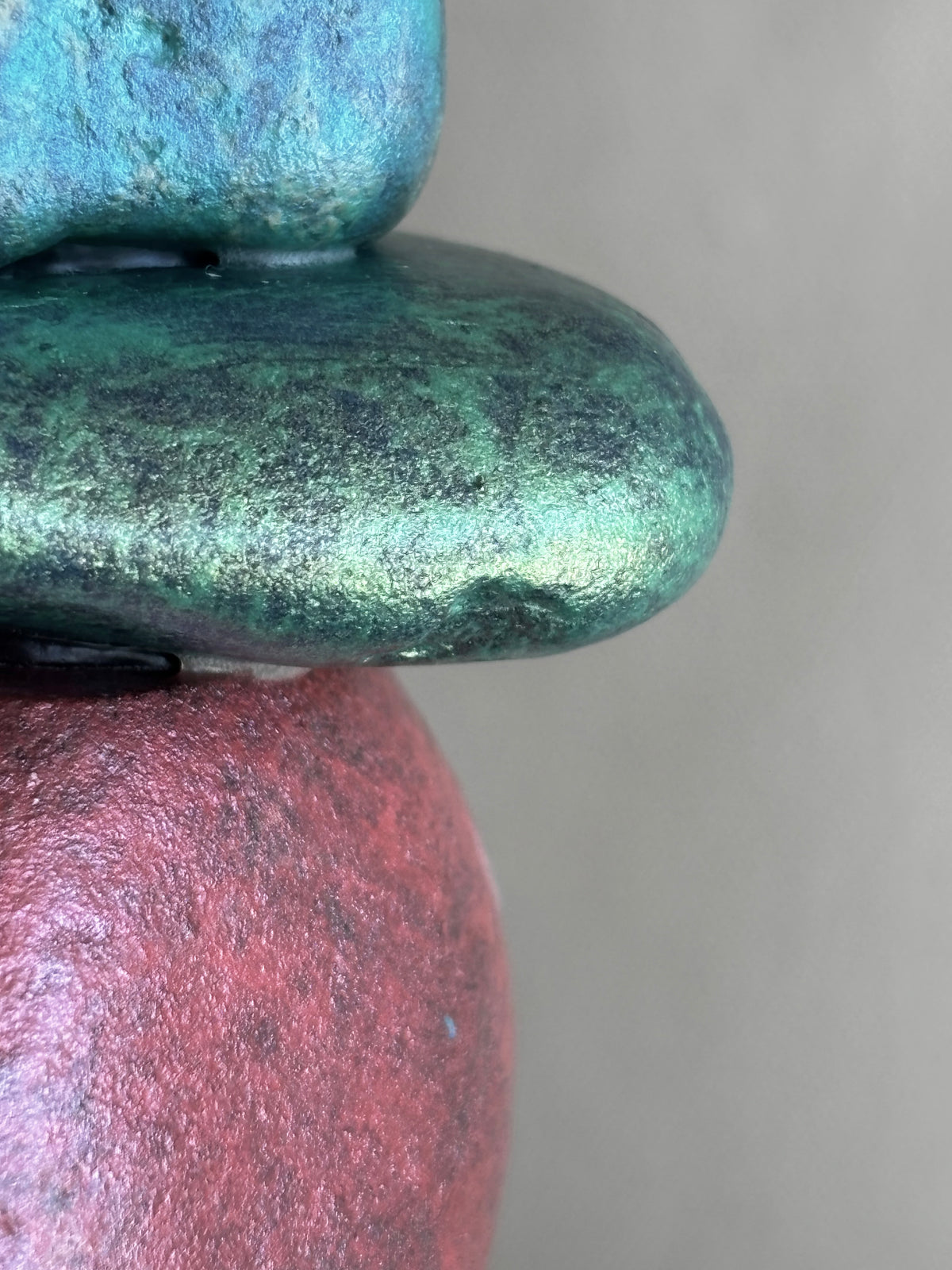 Beautiful very close detail of stones in a brightly colored river rock sculpture by Robert Schott