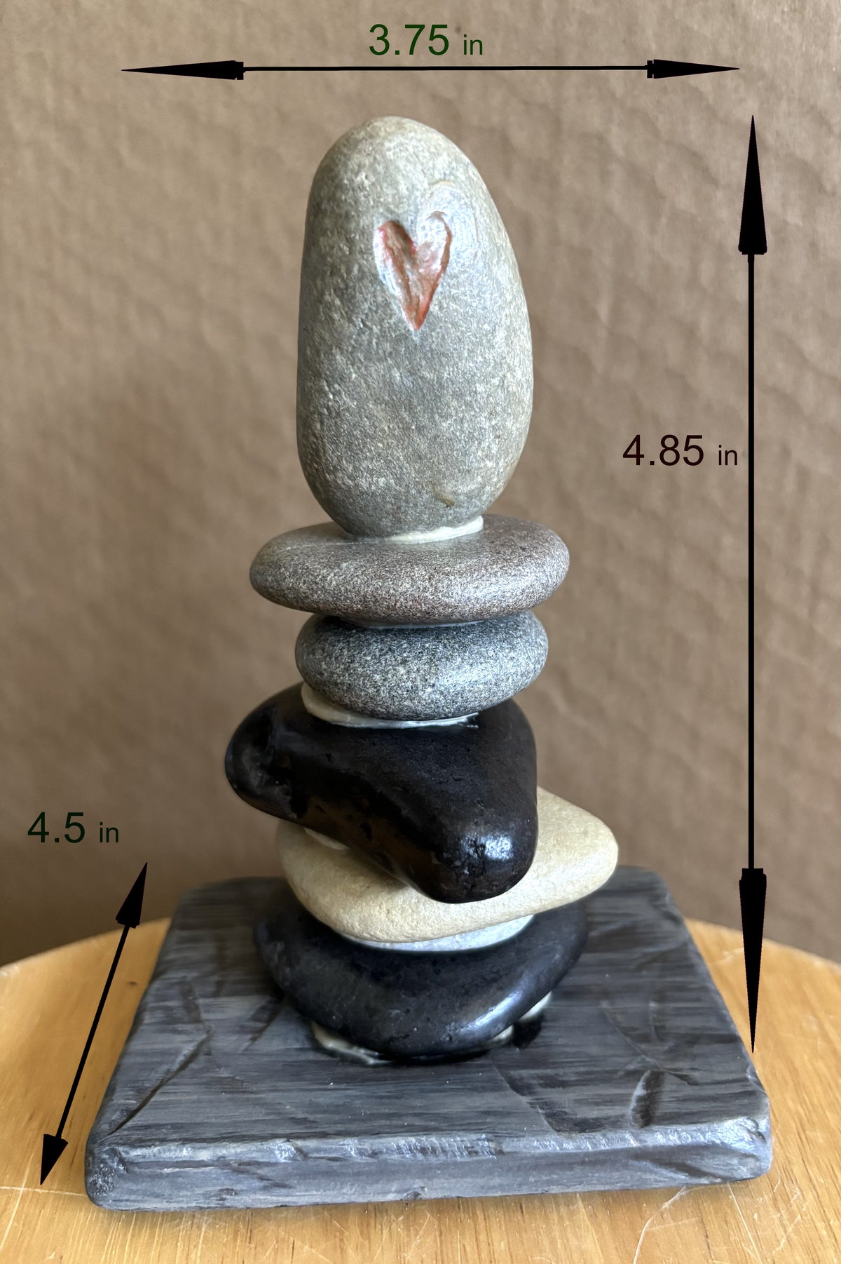 The dimensions of a six stone stacked sculpture with etched red hearts.