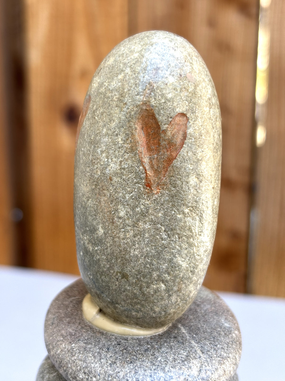 A detail of an etched heart on a stone sculpture by Robert Schott

