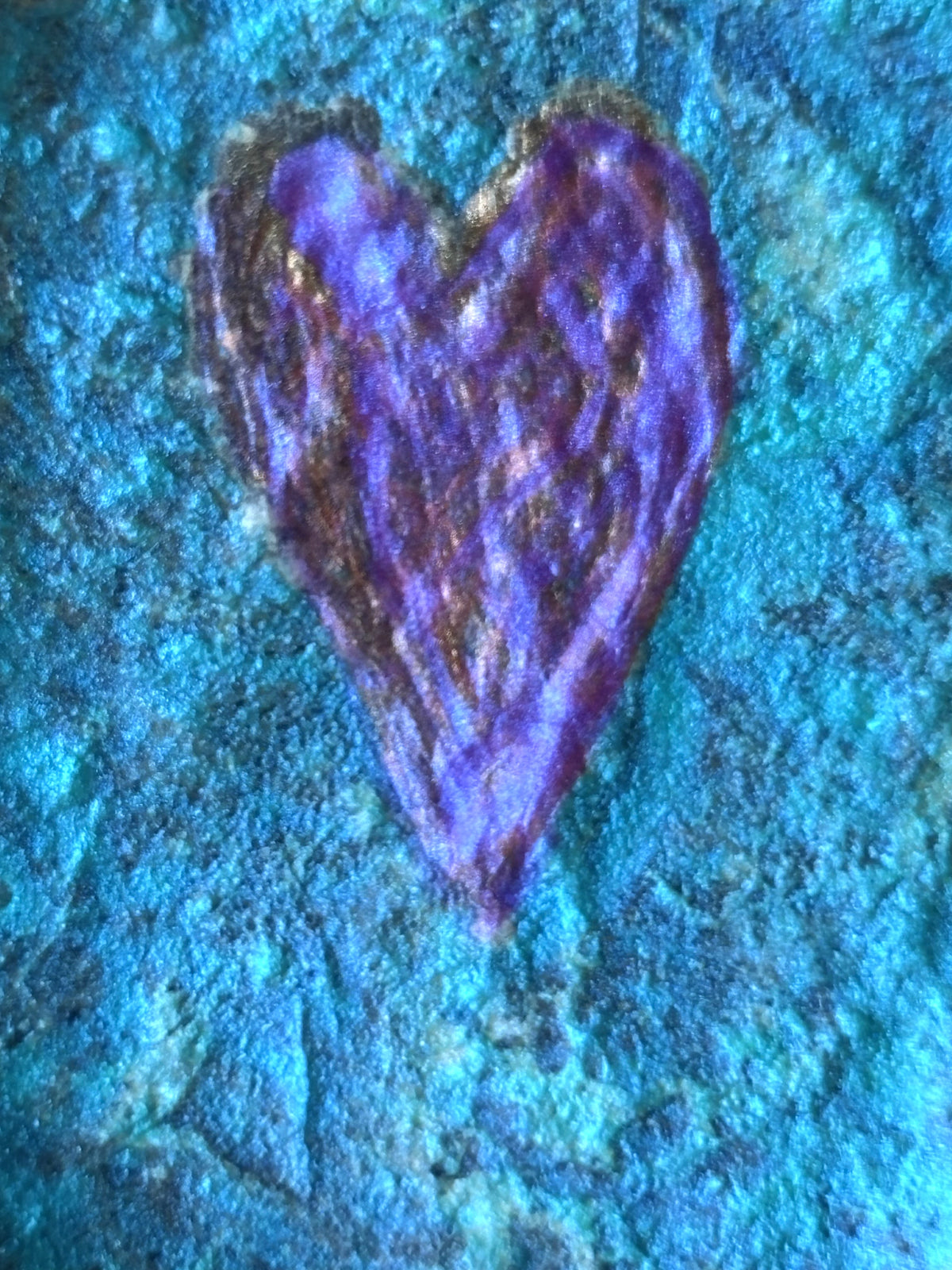 Closeup detail of the etched heart in this stone sculpture by Robert Schott