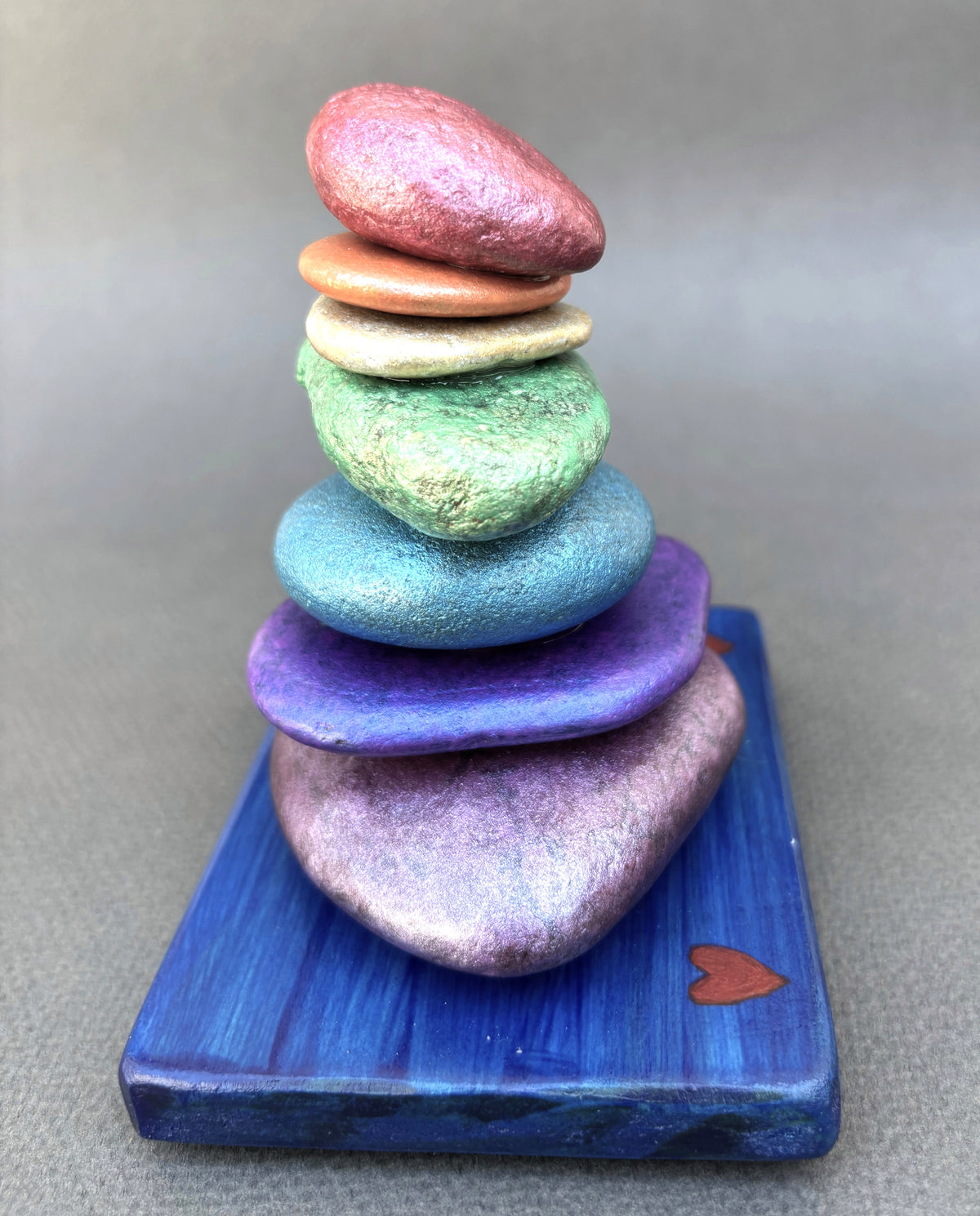 Rainbows are good luck with this seven stone cairn sculpture by Robert Schott