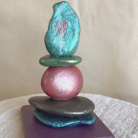 Video for a jewel toned river rock sculpture with two carved hearts in the top stone by Robert Schott