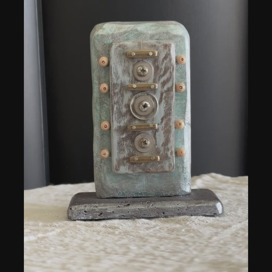 Video of a small Buddhist, symbolic sculpture created with found objects by Robert Schott