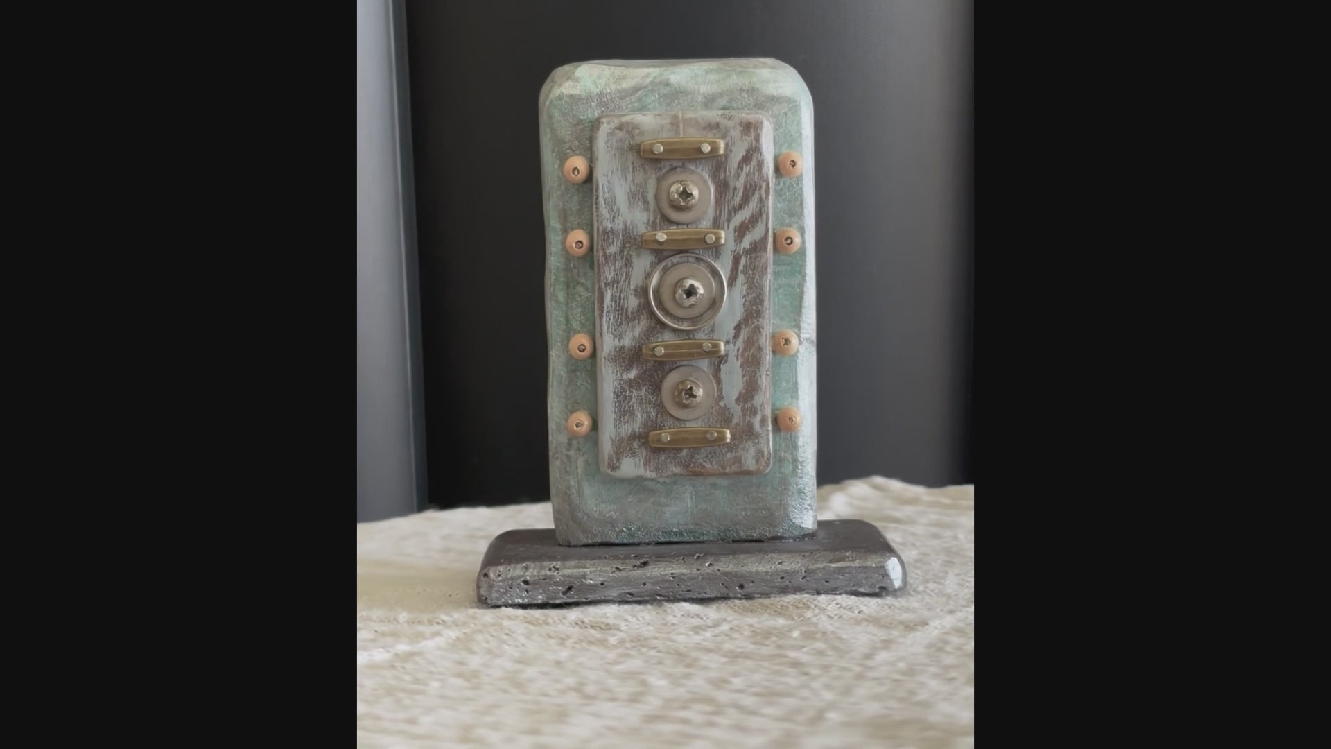 Video of a small Buddhist, symbolic sculpture created with found objects by Robert Schott
