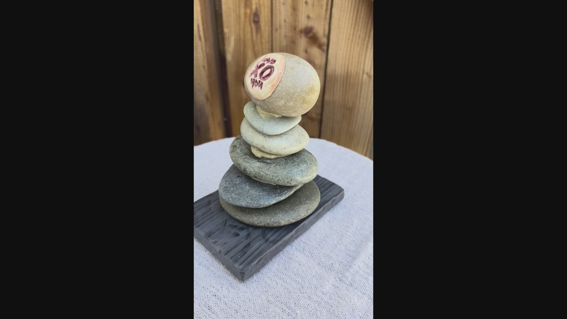 a video of a stacked river rock sculpture.