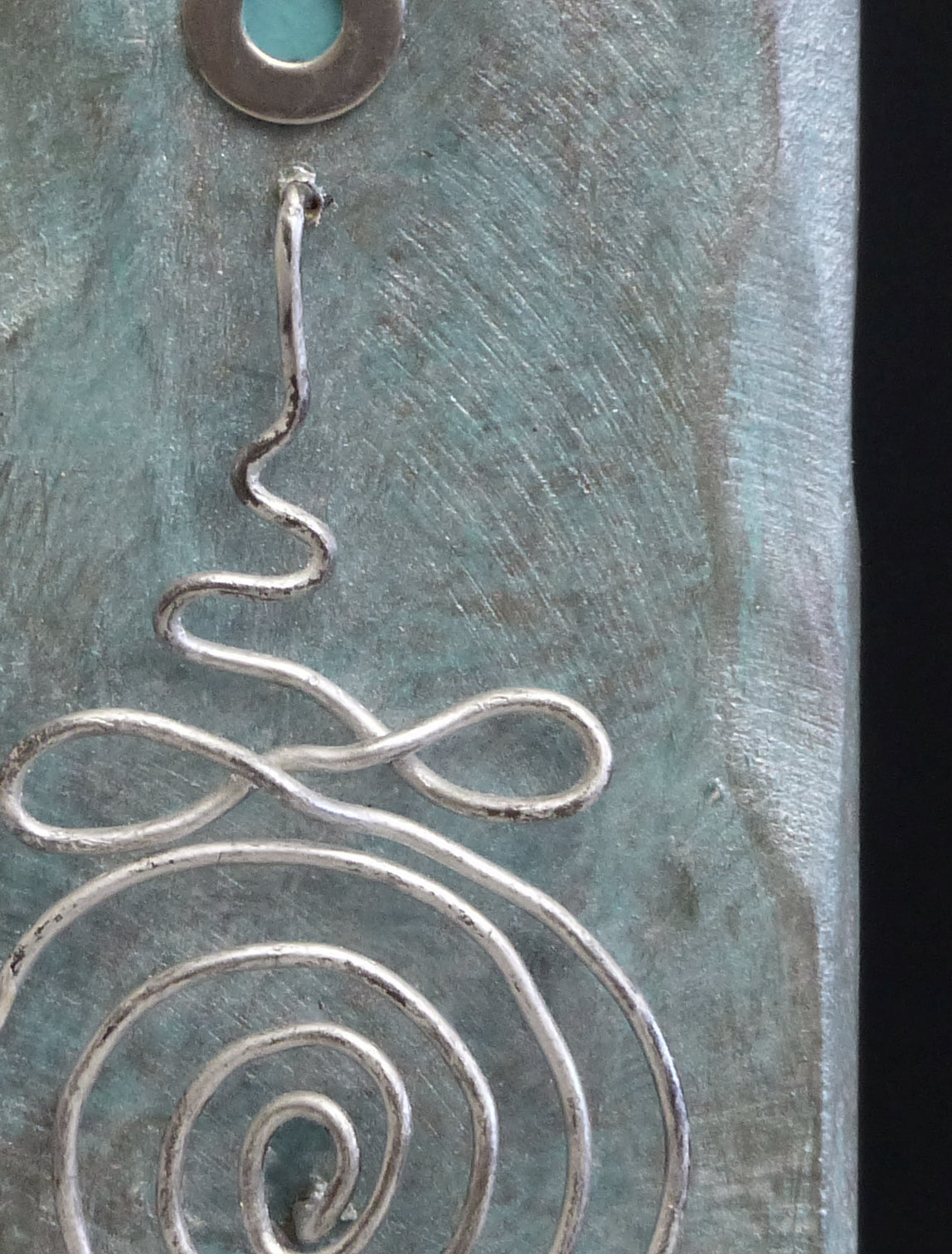 Detail of Buddhist Unalome on a small scultpure.