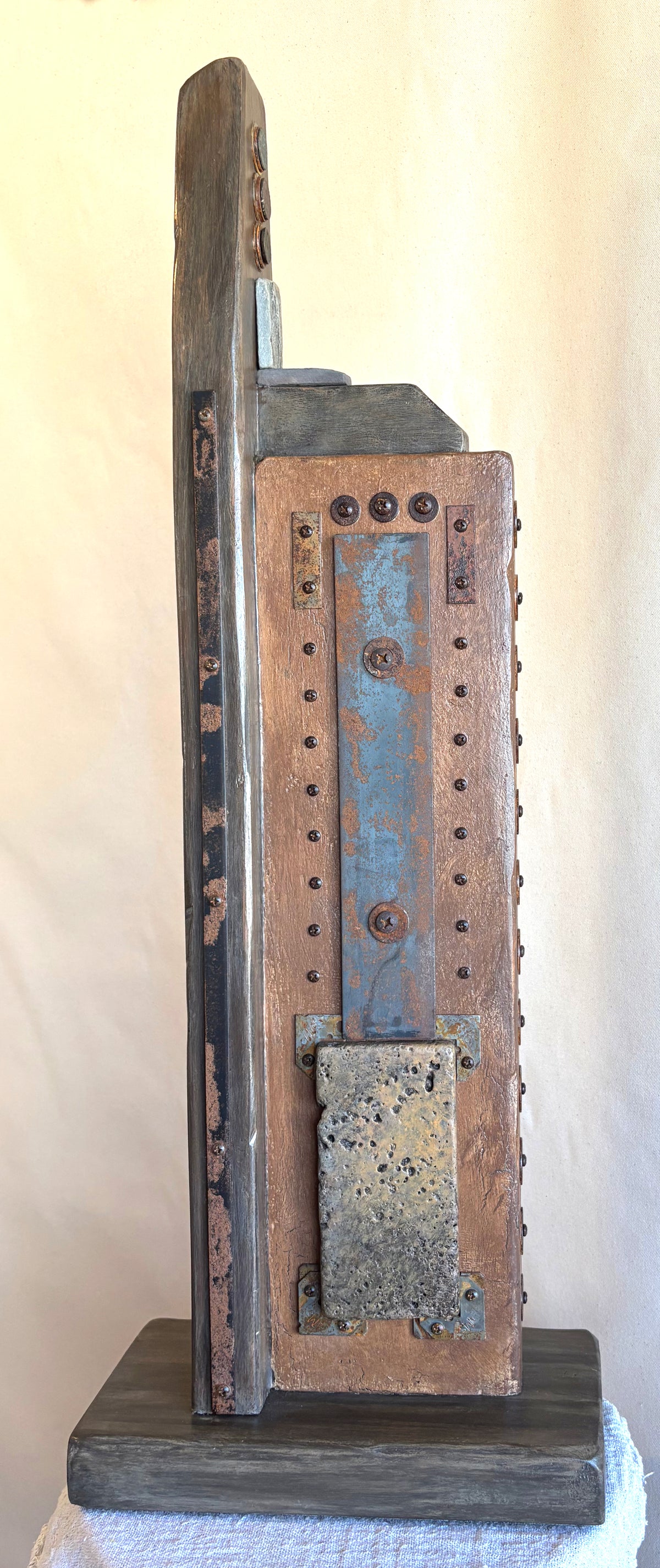 A rustic, Wabi-Sabi inspired sculpture with three ancient coins from Rome and Egypt. Created by Robert Schott