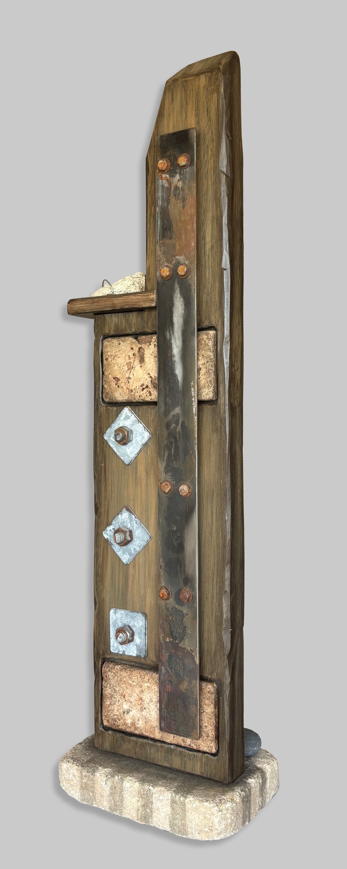 An angle view of a Rustic sculpture, Steel, created with found objects inspired by Wabi Sabi, created by Robert Schott
