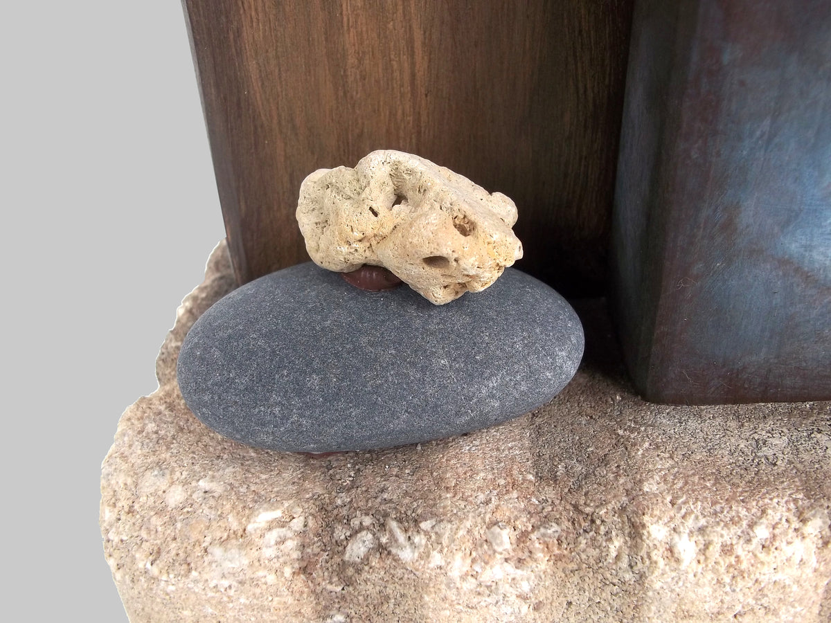 Detail of smooth rock on, Steel, a rustic sculpture by Robert Schott