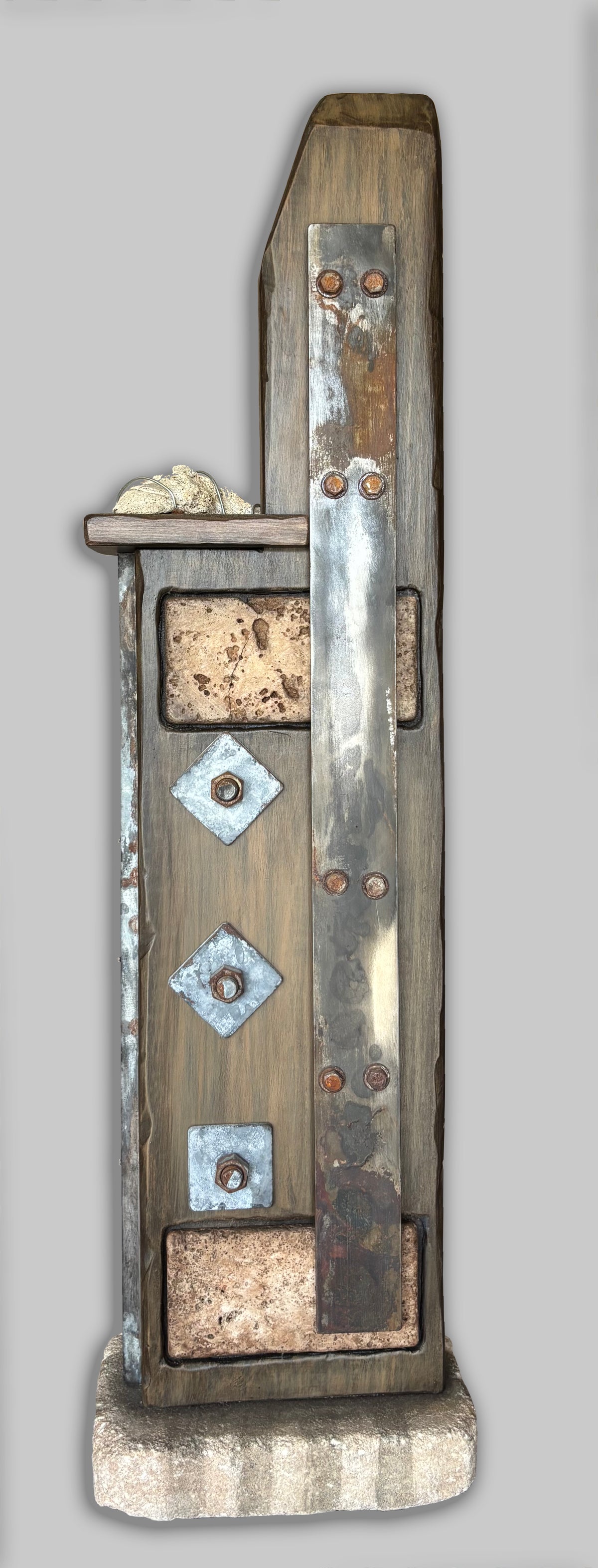 A side view of a Wabi-Sabi sculpture titled Steel, created with found objects, by Robert Schott