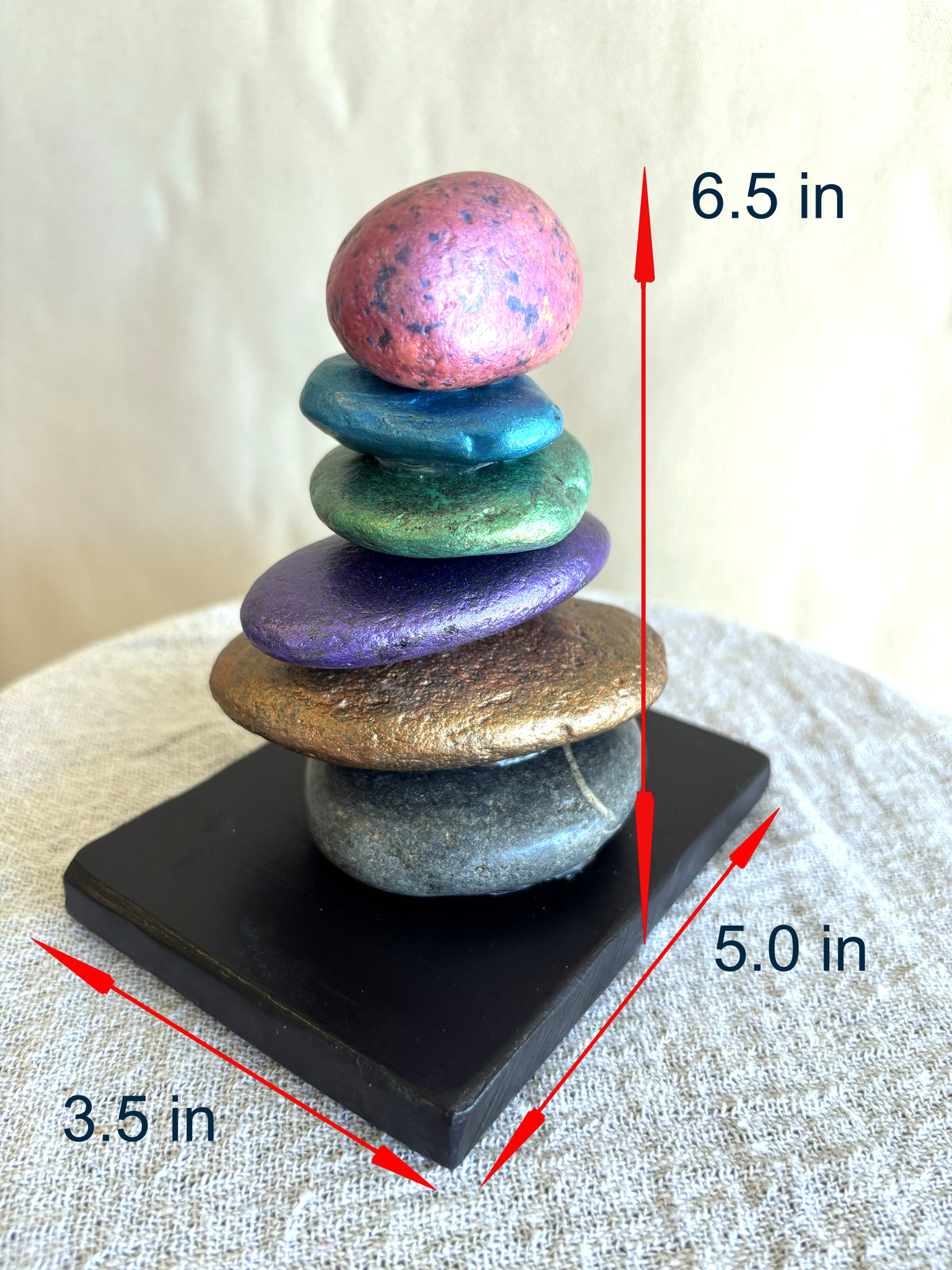 Photo of a jewel toned sculpture showing the dimensions in inches.