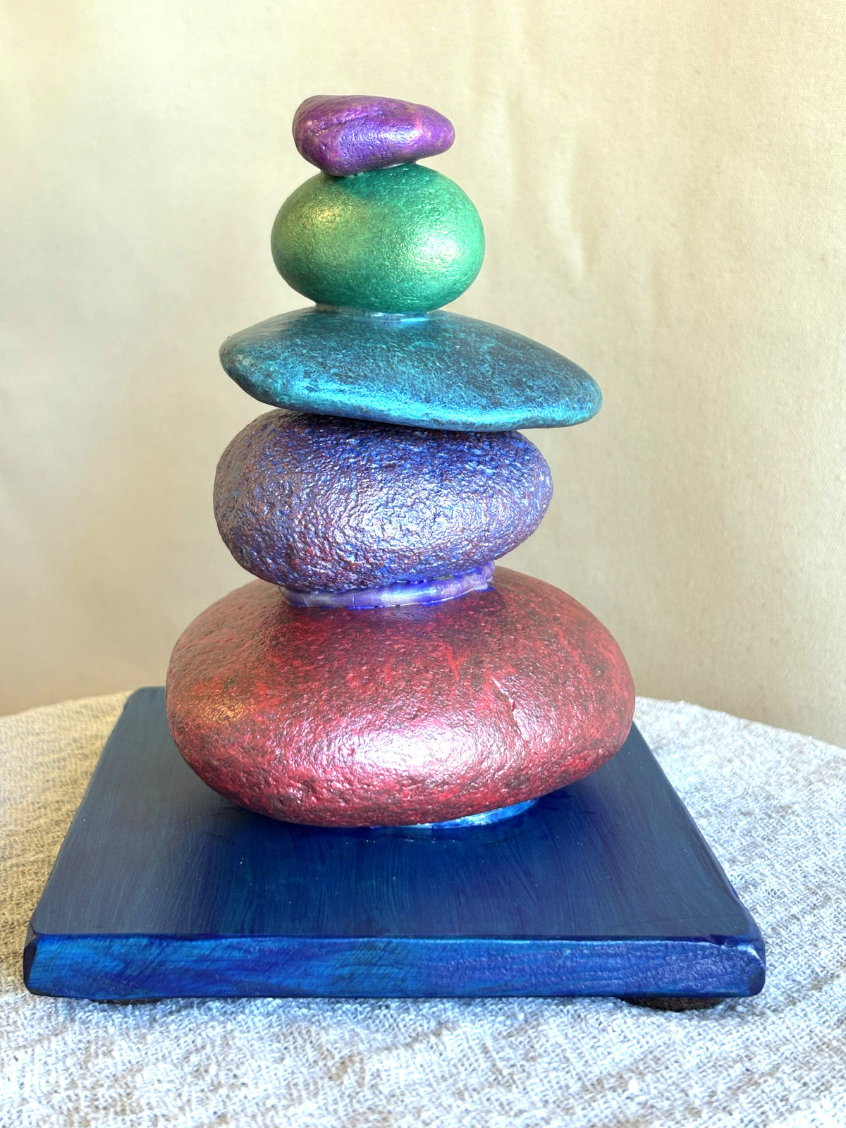 Side view of five jewel toned river rocks from a sculpture by Robert Schott
