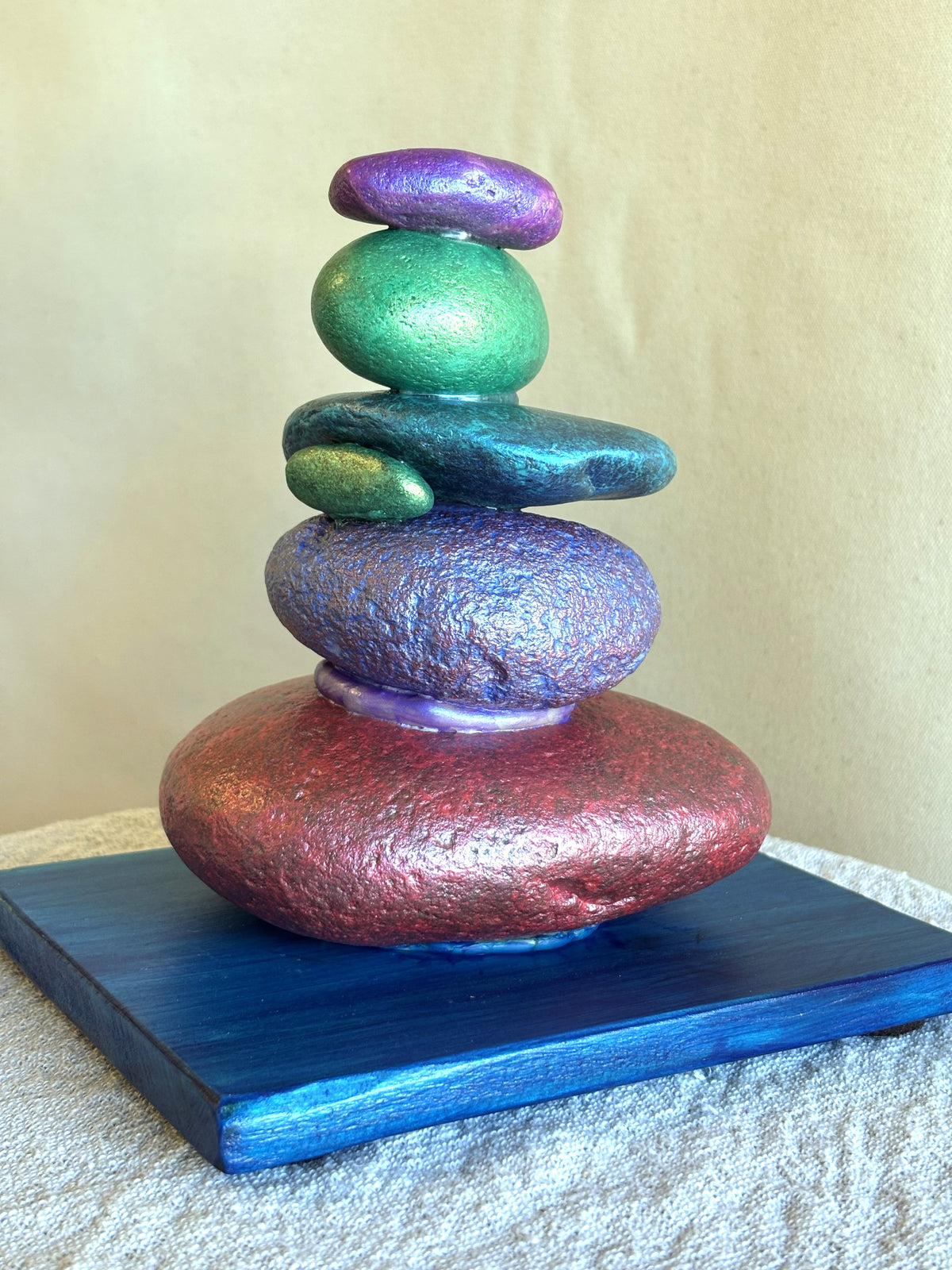 Back view of brightly colored jewel toned rock sculpture by Robert Schott