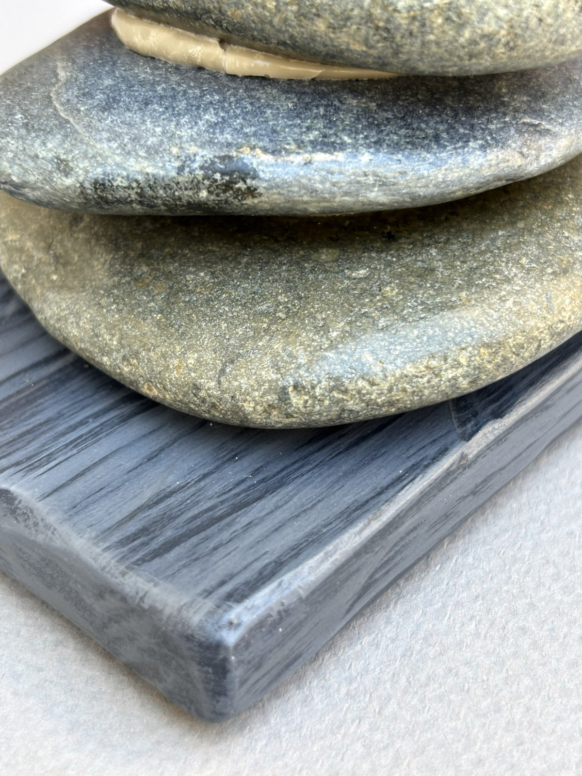 Detail of two river rocks from a tower of love sculpture by Robert Schott